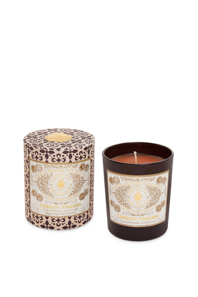 Candle in packaging with decorative label on a white background