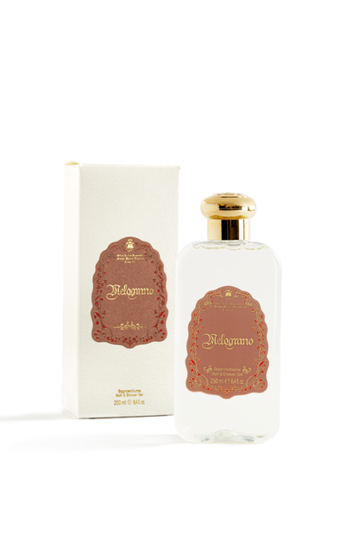 Perfume bottle and packaging with gold cap and decorative label on a white background