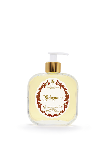 Hand soap bottle with gold pump and decorative label on a white background